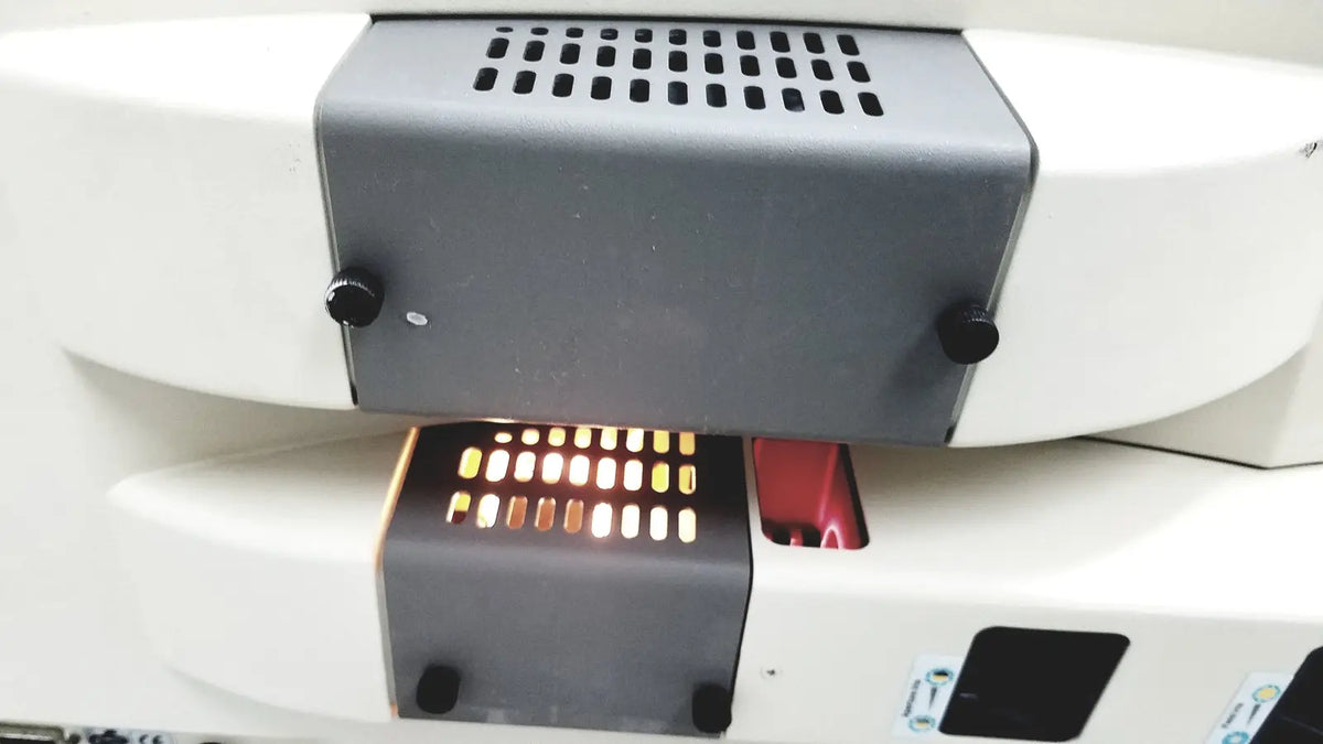 White and gray thermo nicolet continuum infrared microscope with perforated vent panel black knobs and illuminated display