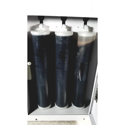 Three cylindrical water filtration cartridges with dark contents and white caps in a metallic housing of thermo scientific easypure ii d7401 lab grade system