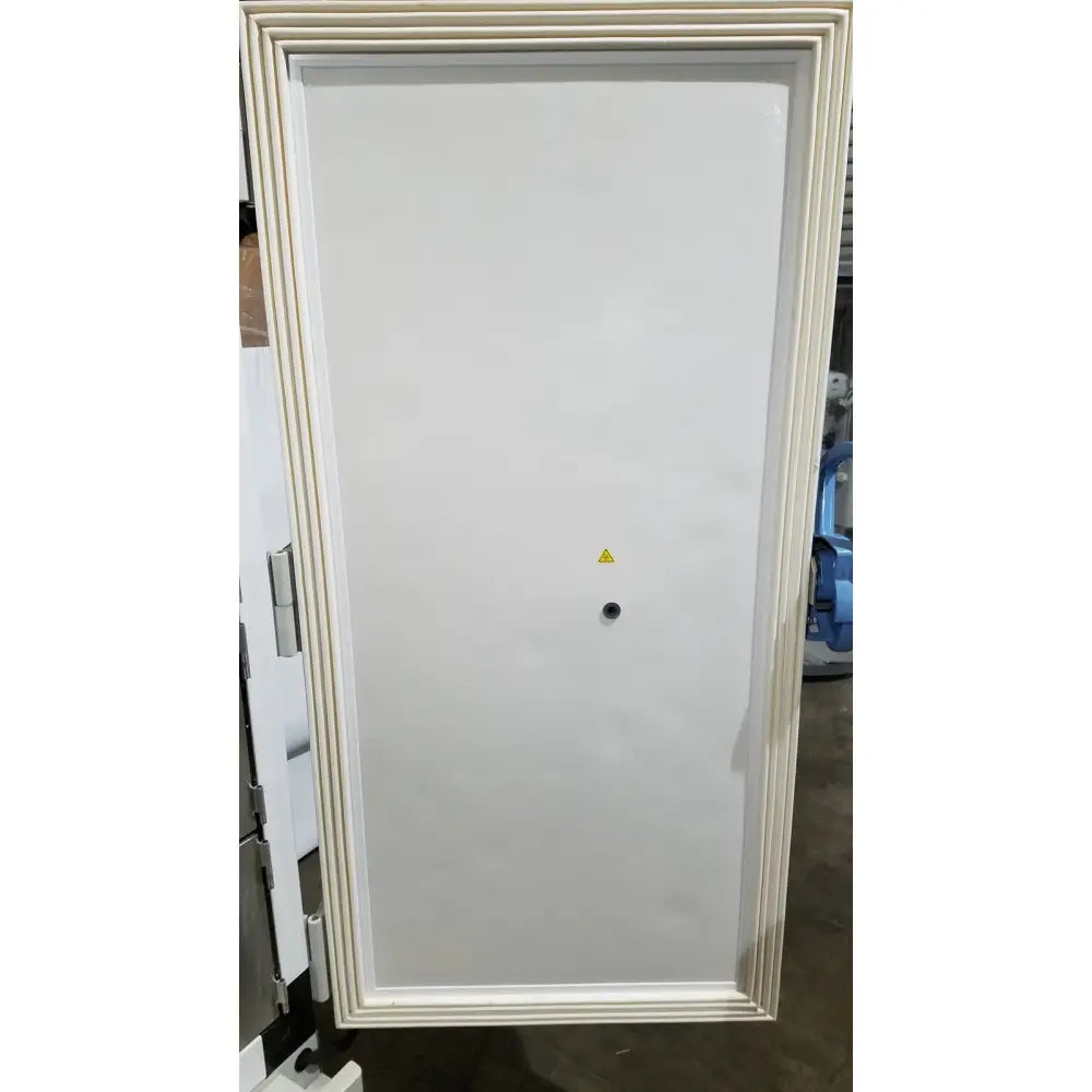 White industrial-grade electrical panel with cream beveled frame and warning symbol on thermo scientific forma freezer