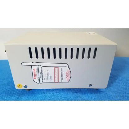 White rectangular thermo scientific gas guard model 3050 with black ventilation slits and support services label on back side
