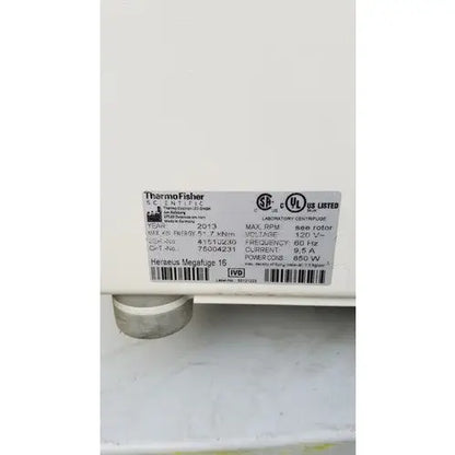 White rectangular label with black text and logos on the back of a thermo scientific heraeus megafuge 16 laboratory centrifuge