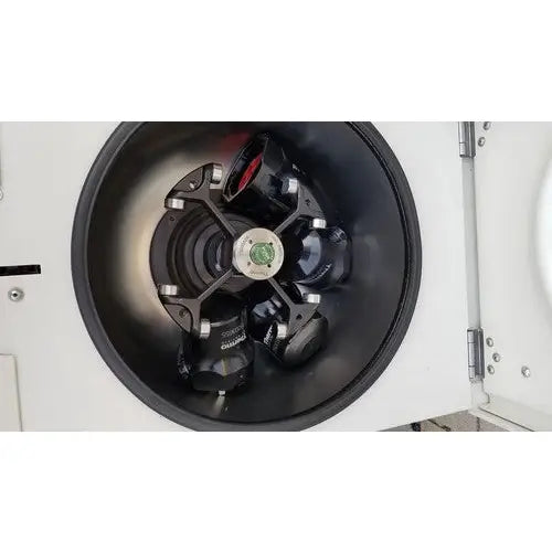 Black rotor with red and green accents inside the thermo scientific heraeus megafuge 16 centrifuge chamber