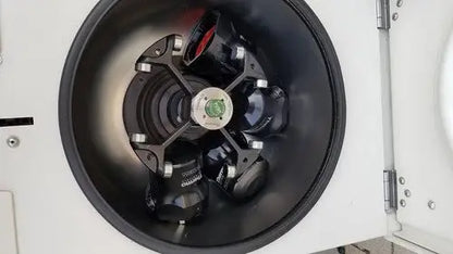 Black rotor with red and green accents inside the thermo scientific heraeus megafuge 16 centrifuge chamber