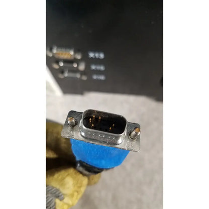 Blue insulated db9 serial connector with metallic housing and visible pins on thermo scientific microm hm 340e device