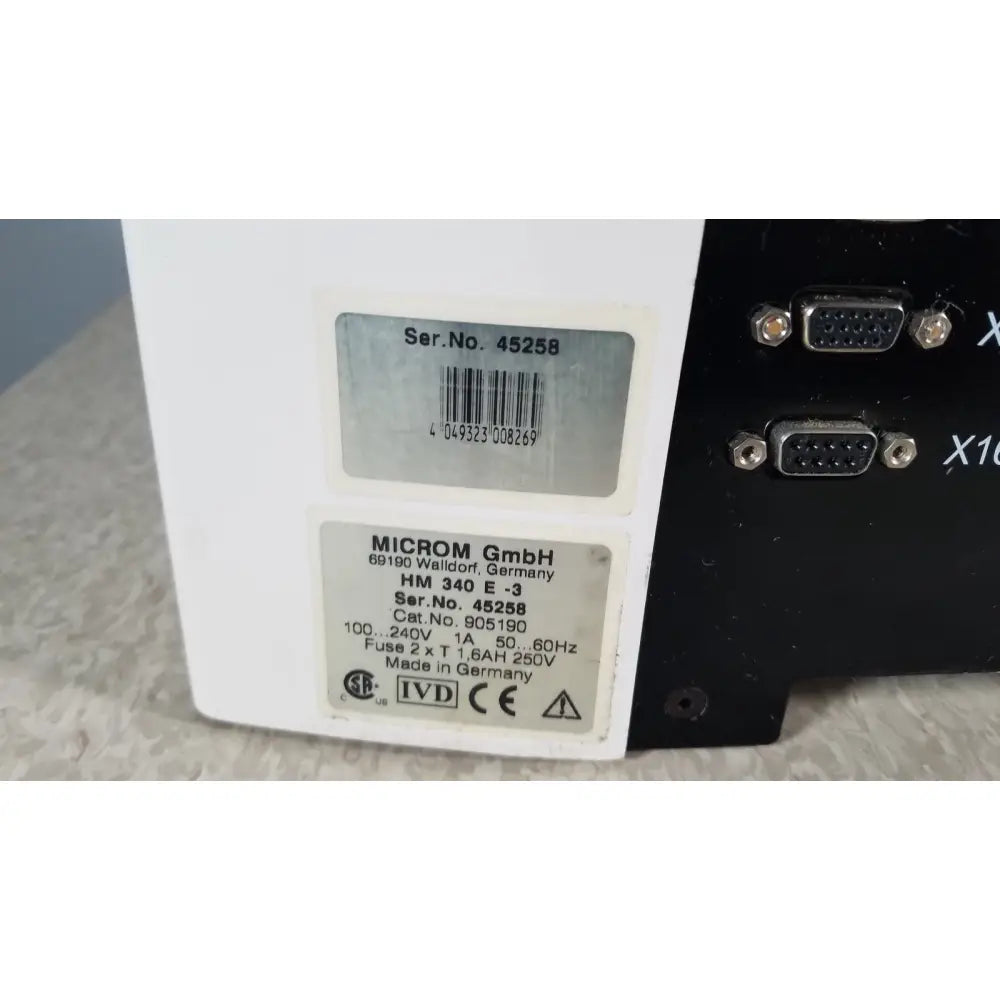 White rectangular thermo scientific microm hm 340e electronic device with black vga ports made in germany back side view