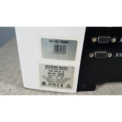 White rectangular thermo scientific microm hm 340e electronic device with black vga ports made in germany back side view