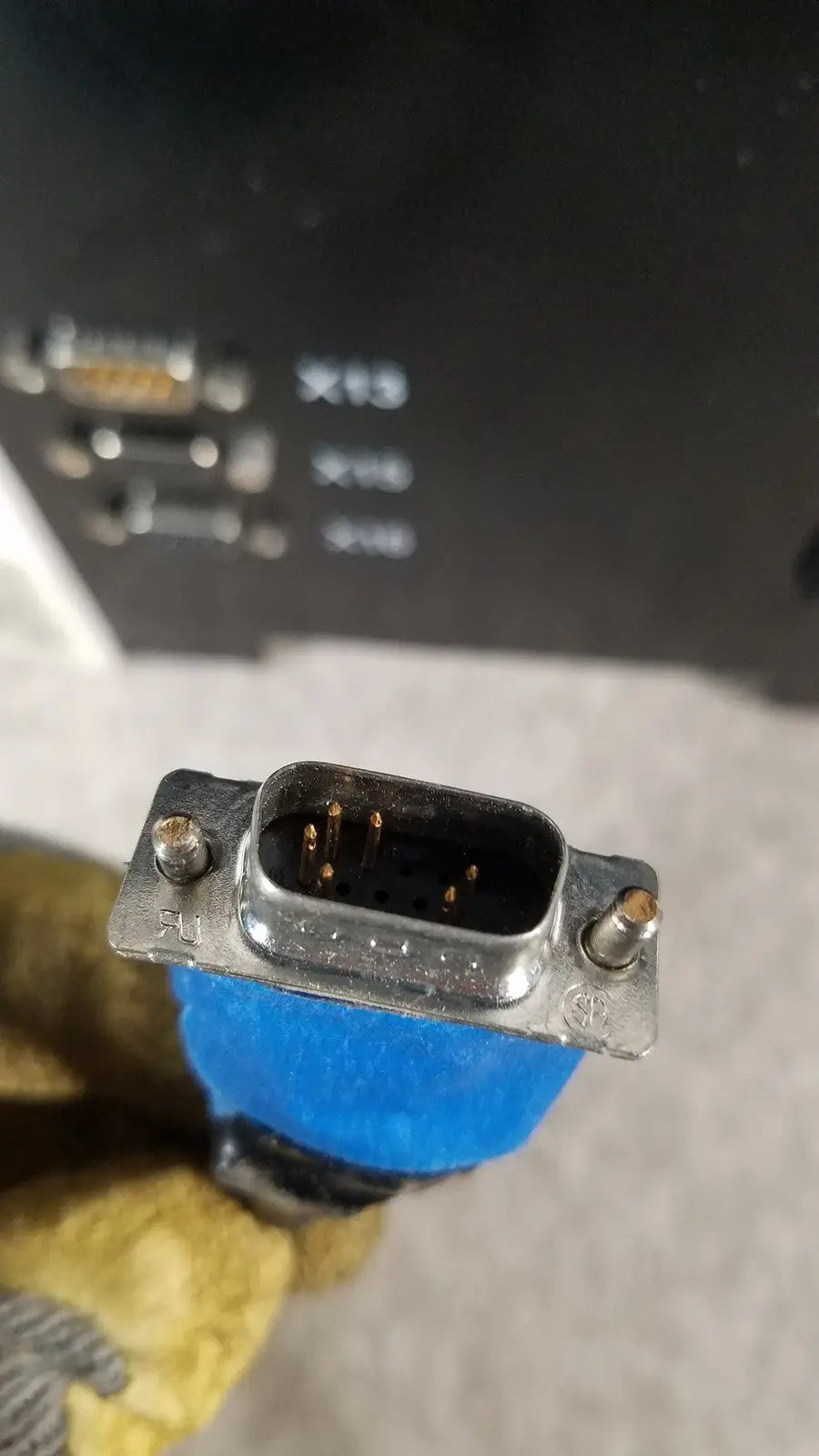 Blue insulated db9 serial connector with metallic housing and visible pins on thermo scientific microm hm 340e device
