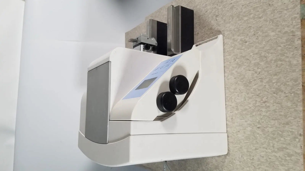 White and gray thermo scientific microm hm 340e medical device with two black circular dials on front panel serial no 45258