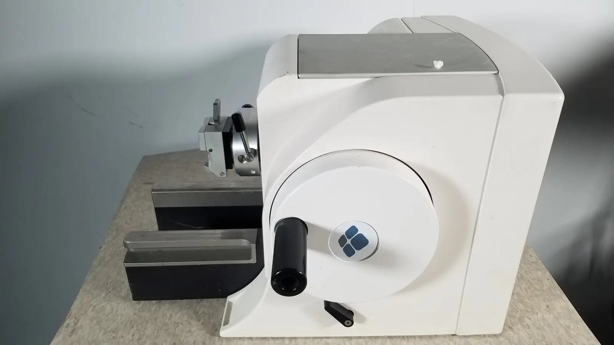White industrial material testing machine thermo scientific microm hm 340e with circular dial black handle and blue logo serial 45258