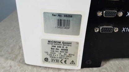 White rectangular thermo scientific microm hm 340e electronic device with black vga ports made in germany back side view