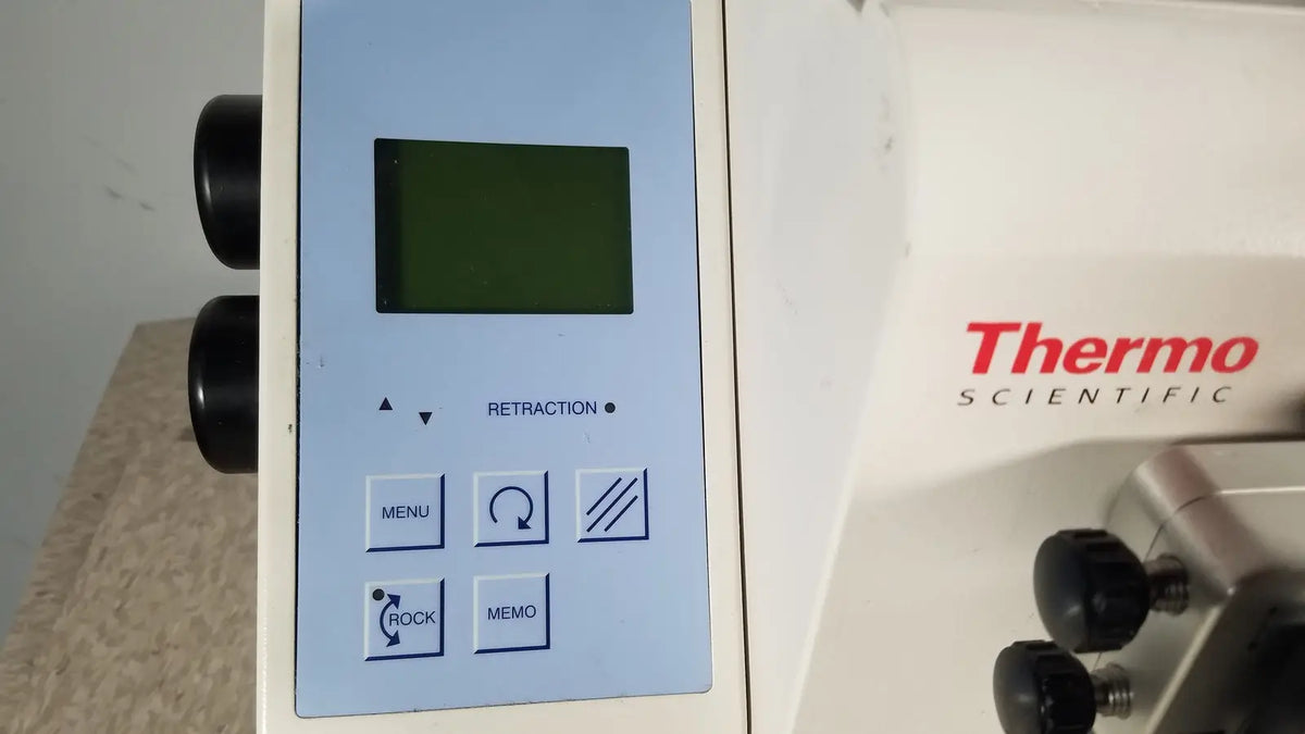 White thermo scientific microm hm 340e laboratory instrument with light blue control panel and green display screen