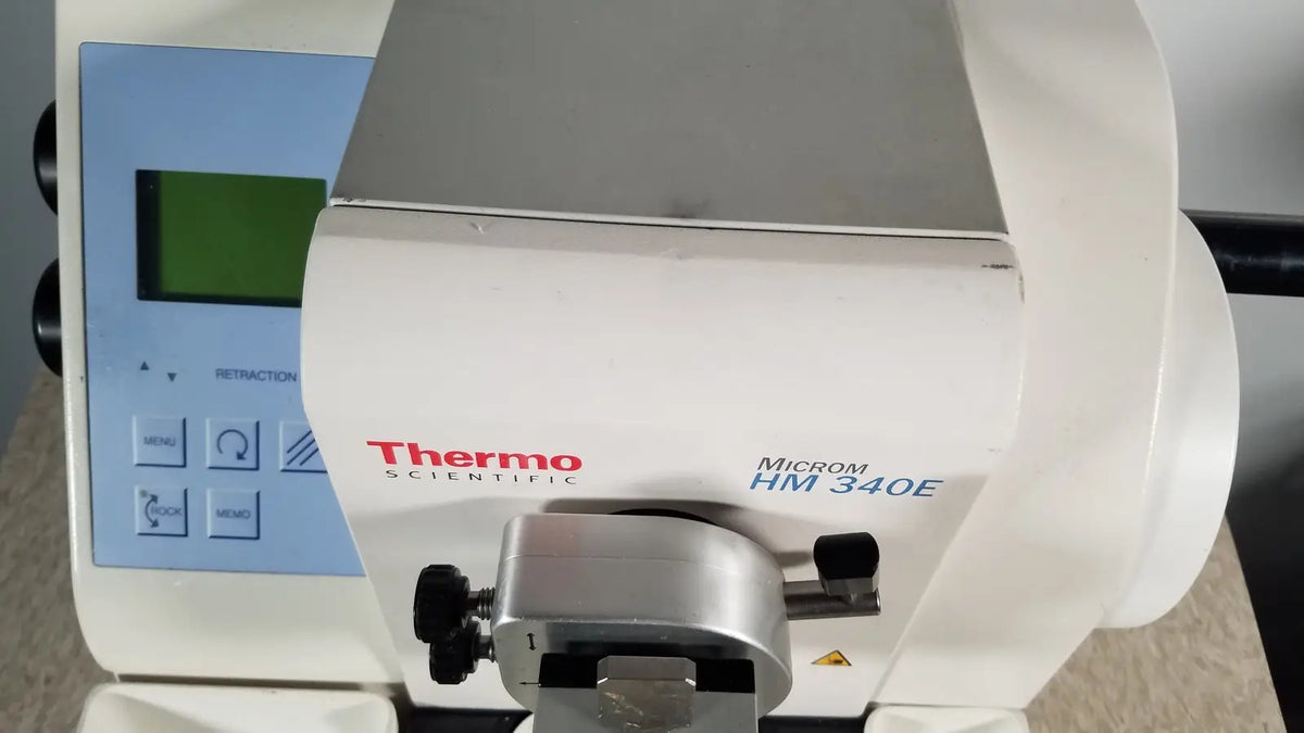 White thermo scientific microm hm 340e dental curing light with silver metallic clamp and black knobs serial no 45258