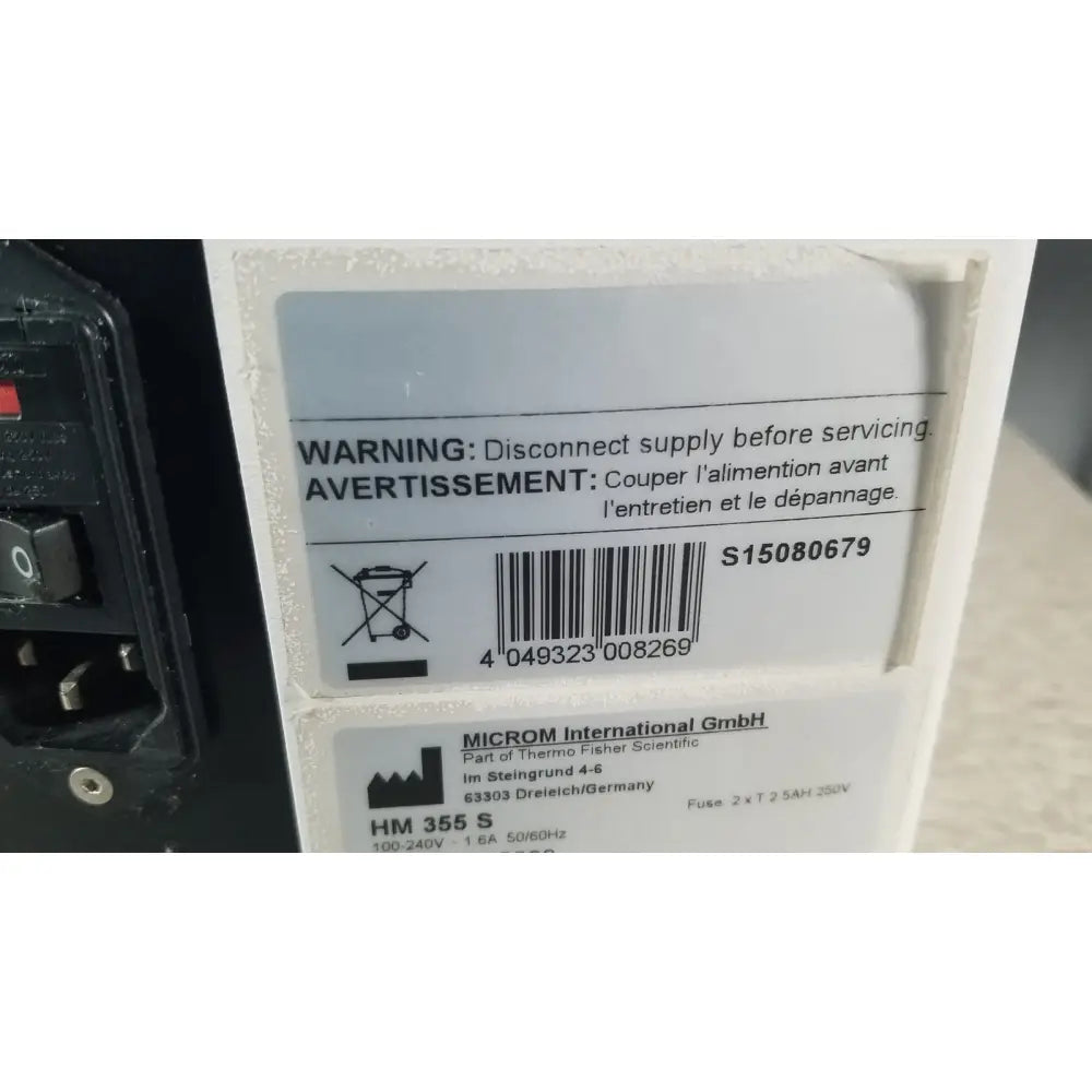 White rectangular label with black text and barcode showing manufacturer details on thermo scientific microm hm 355 s rotary microtome