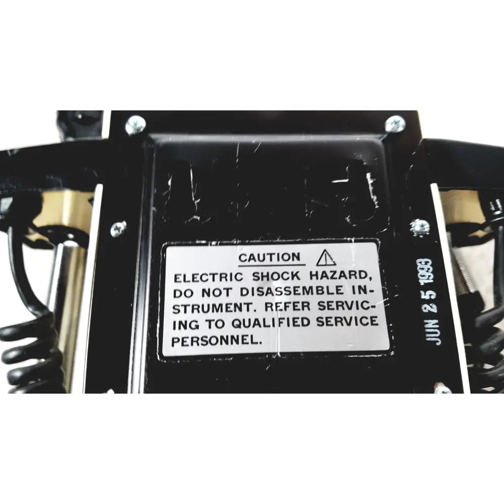 Black plastic housing with white caution label dated june 2 1983 on back of thermo scientific slidemate laboratory printer