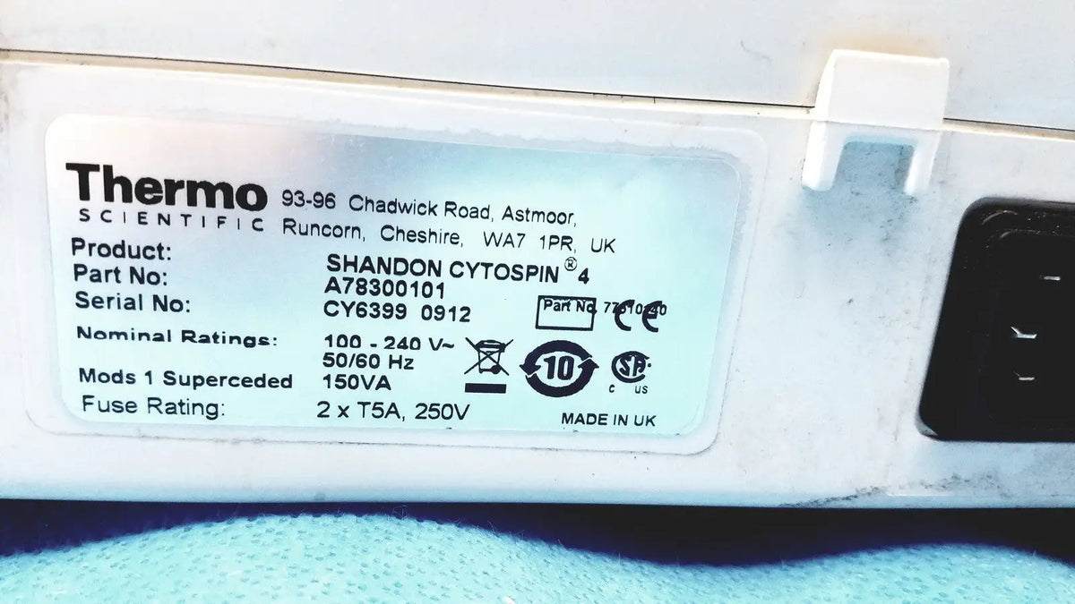 White plastic label with black text showing specifications for thermo shandon cytospin 4 centrifuge with rotor for reuse medical purposes