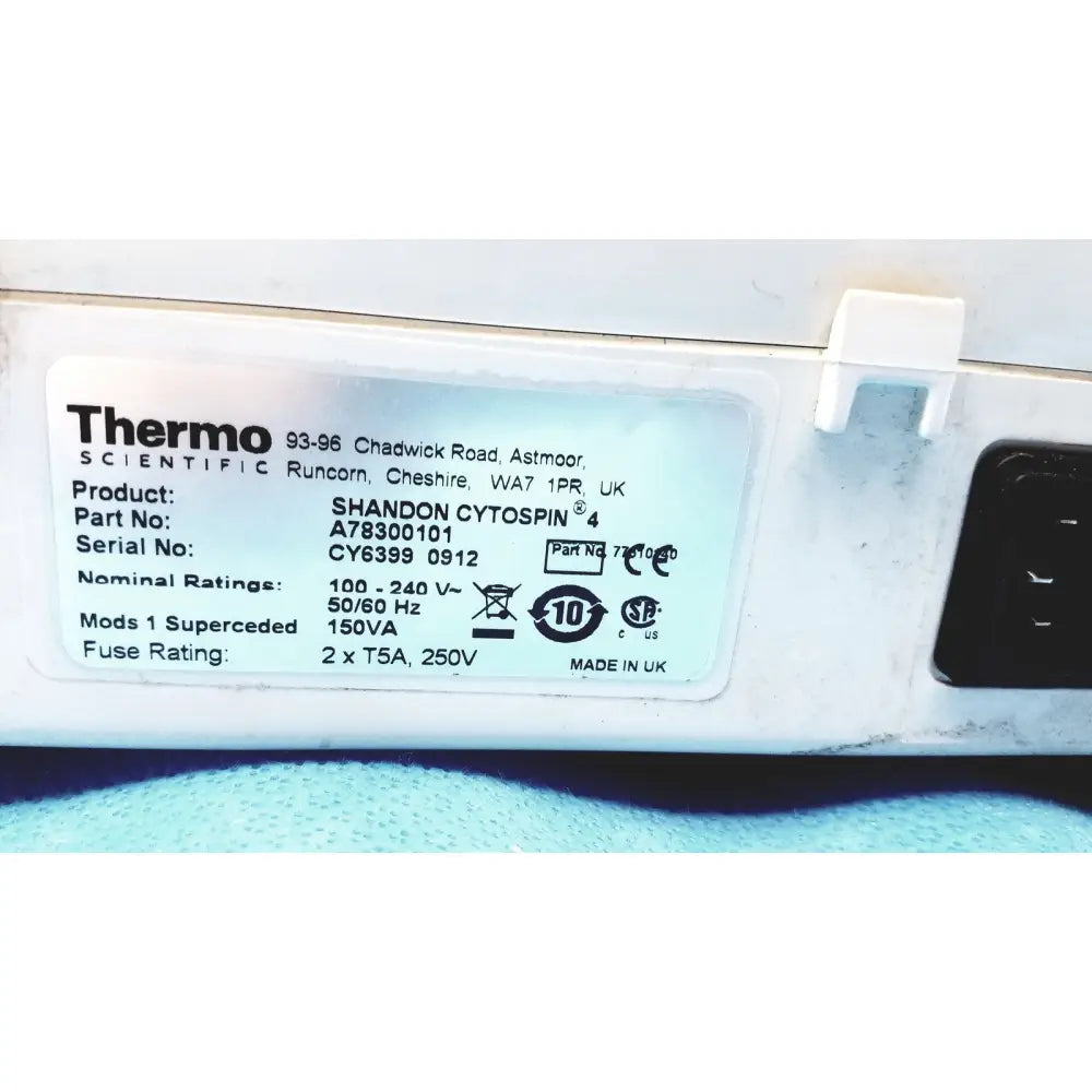 White plastic label with black text showing specifications for thermo shandon cytospin 4 centrifuge with rotor for reuse medical purposes