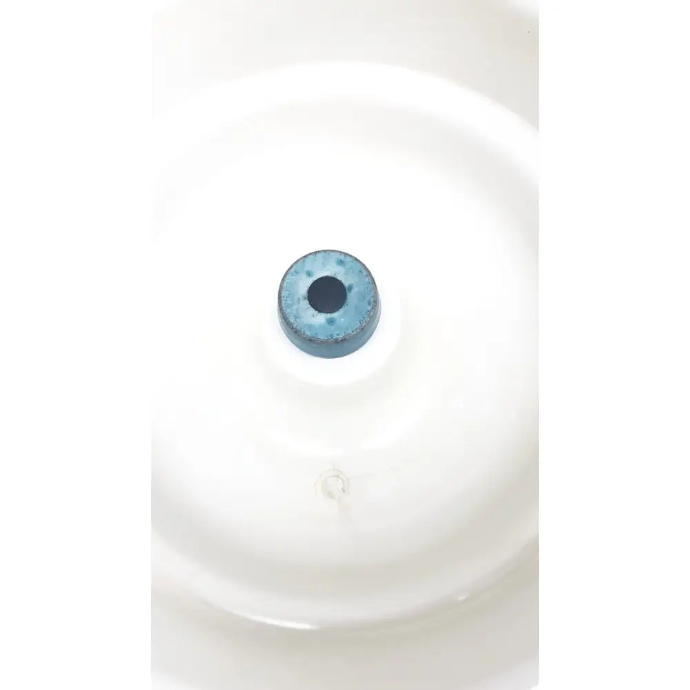 A blue ceramic circular component with a central hole for thermo shandon cytospin control a78300101 centrifuge use