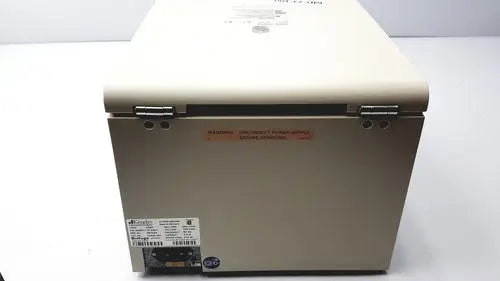 Beige thermo sorvall biofuge primo centrifuge with metal latches and warning label on the side for laboratory use