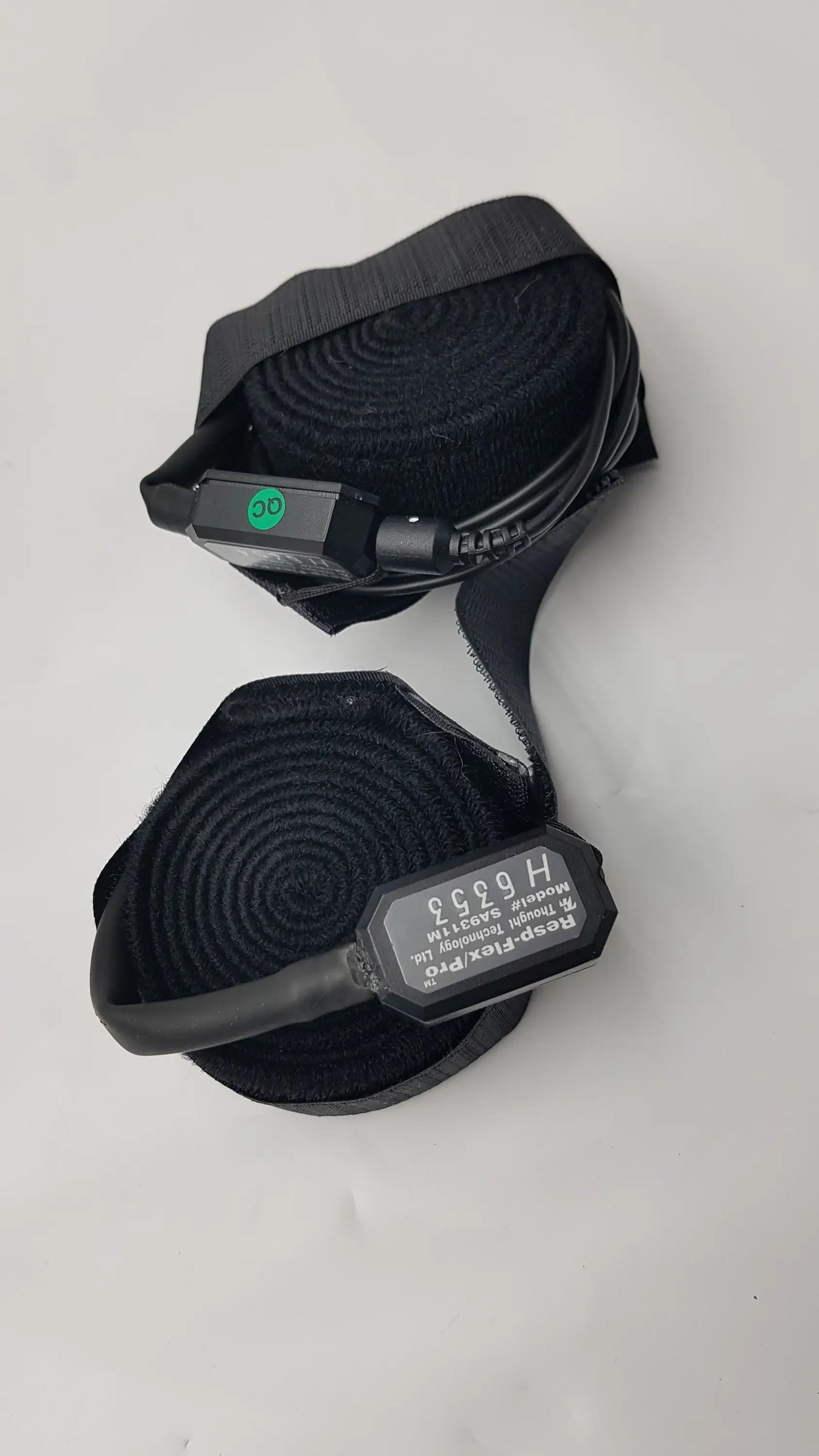Black resp-flex pro medical oxygen delivery device with coiled tubing and labeled control unit for thought technology data acquisition