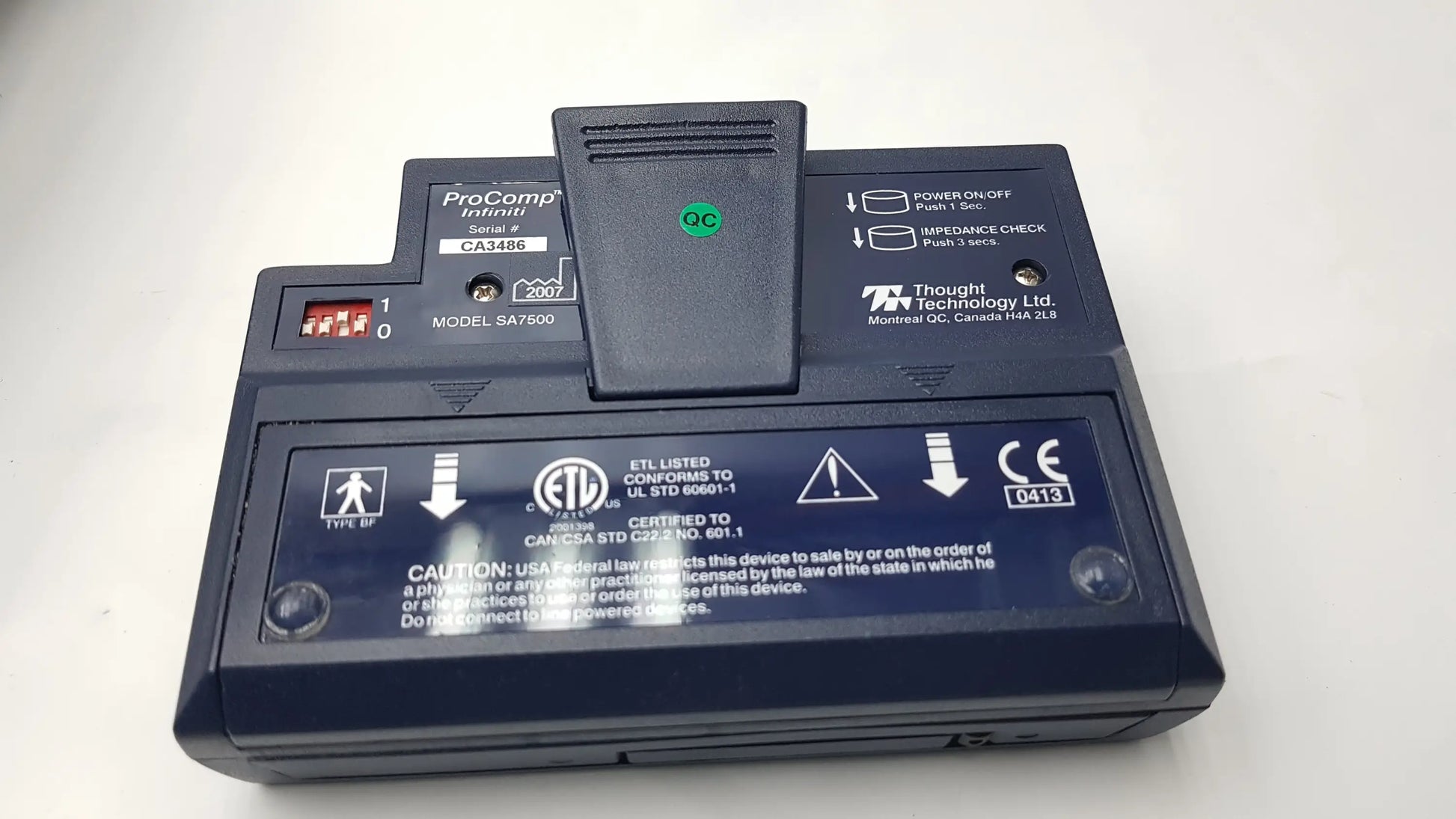 Black plastic thought technology procomp infinite model sa7608 device with green qc indicator light and labeled power buttons for physiological data acquisition