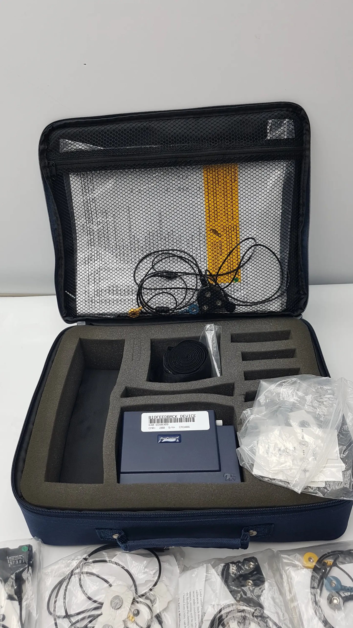 Navy blue foam-lined case containing a thought technology sa7500 procomp infiniti device for physiological data acquisition