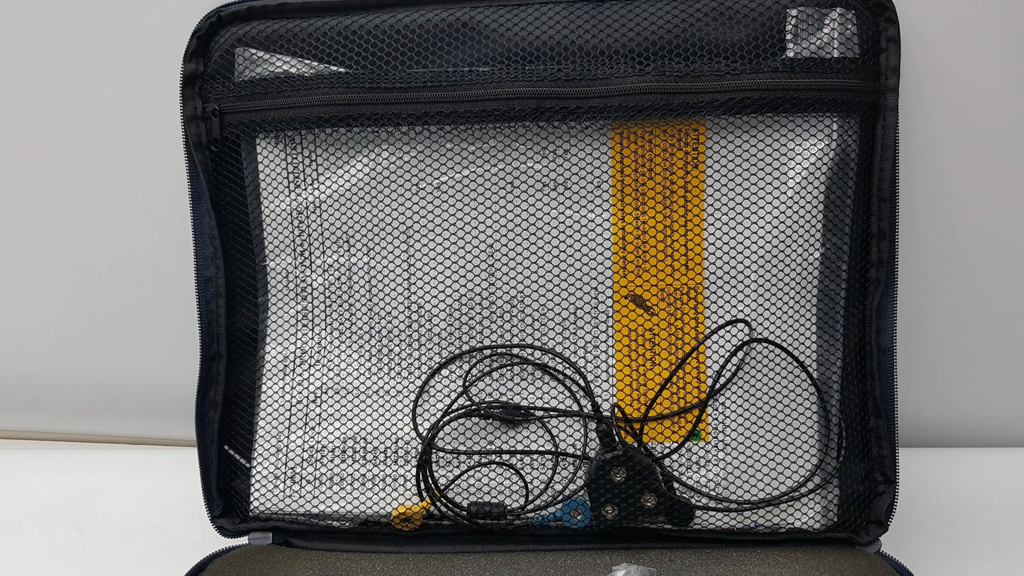 Black mesh organizer bag with zipper containing coiled black cables and yellow item for thought technology physiological data acquisition