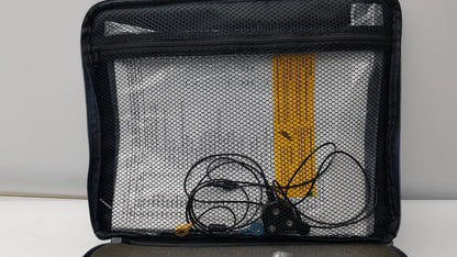 Black mesh organizer bag with zipper containing coiled black cables and yellow item for thought technology physiological data acquisition