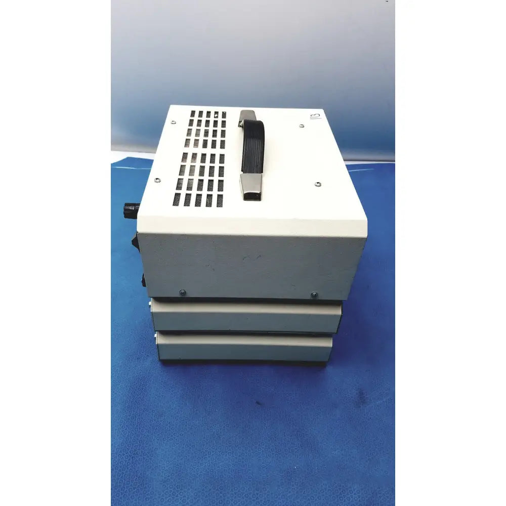 White rectangular rt-200 calibration analyzer with black handle and ventilation grille stacked in timeter instrument corporation product