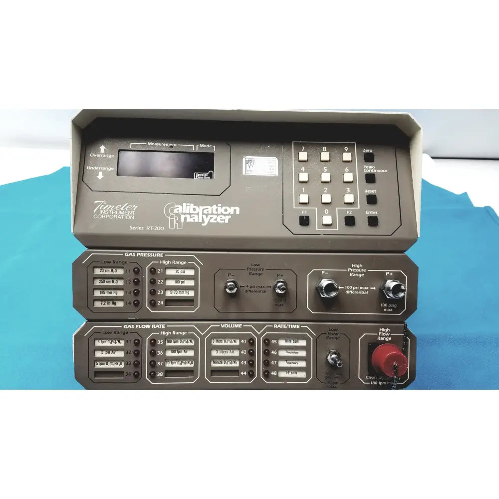 Gray metal timeter instrument corporation RT-200 calibration analyzer with black buttons and digital gas flow control panels