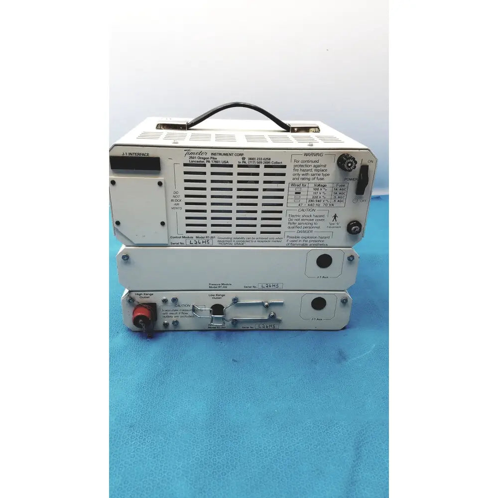 Stacked white metal power supply units with black handles and control knobs from timeter instrument corporation rt-200 calibration analyzer