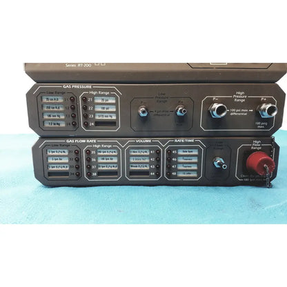 Black industrial gas control panel with labeled dials and switches for pressure flow rate volume and time by timeter instrument corporation