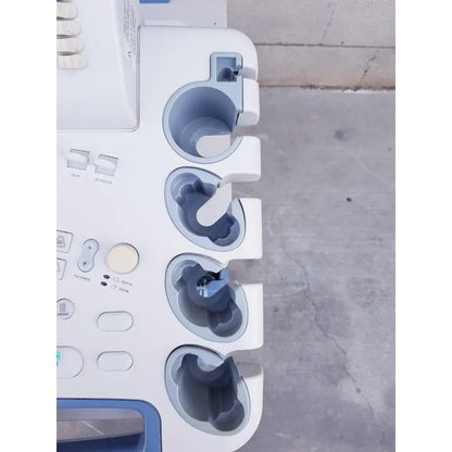 White and blue toshiba nemio 10 ultrasound machine with multiple circular probe holders missing parts as is view