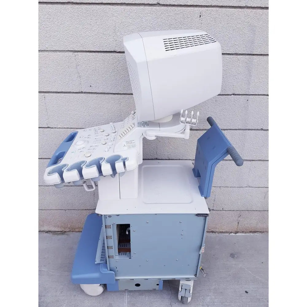 White and blue toshiba nemio 10 ultrasound machine on wheeled cart with monitor and control panel for reuse medical use as is