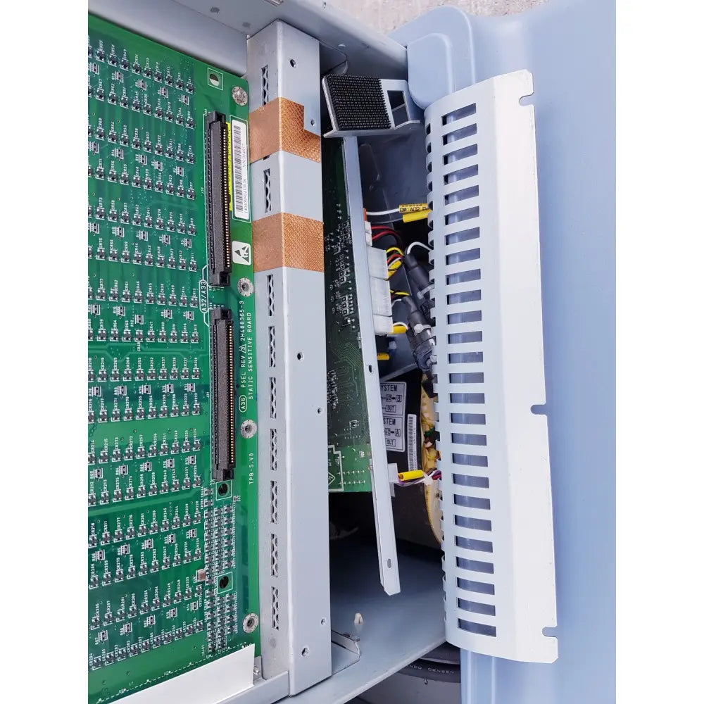 Green circuit board with silver connectors and white brackets inside gray enclosure of toshiba nemio ultrasound machine reuse medical
