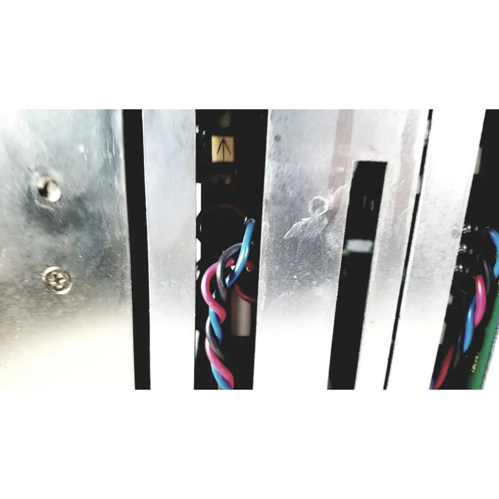 Silver metallic vertical slats with visible screws and colorful wires on the back of toshiba ra power rad92-1008 power supply