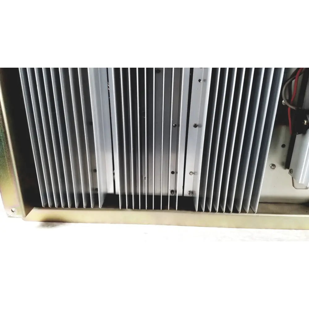 Silver metallic heat sink with vertical fins and mounting screws on toshiba ra power rad92-1008 power supply