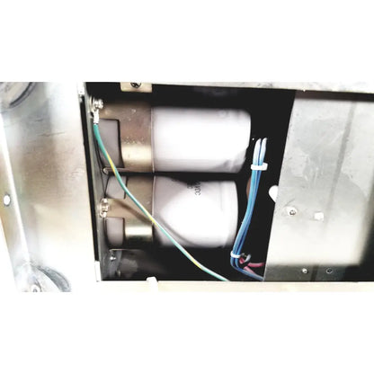 Two white cylindrical capacitors with metallic ends secured by wires inside metal enclosure of toshiba ra power rad92-1008 power supply
