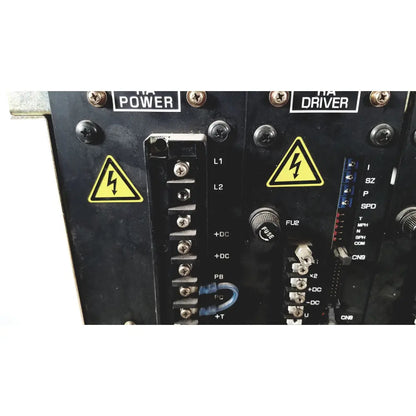 Black industrial control panel of toshiba ra power rad92-1008 dc power supply with yellow warning labels and terminal blocks