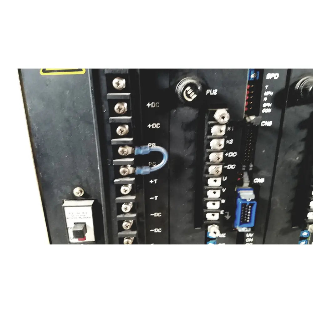 Blue plastic u-shaped terminal connector attached to black industrial control panel on toshiba ra power rad92-1008 power supply