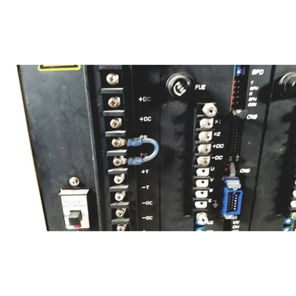 Blue plastic u-shaped terminal connector attached to black industrial control panel on toshiba ra power rad92-1008 power supply