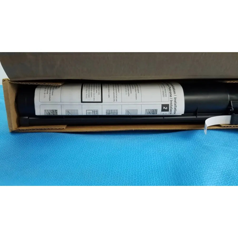 Black cylindrical caulking gun with white label for genuine toshiba toner t-fc28-y original and genuine toshiba product