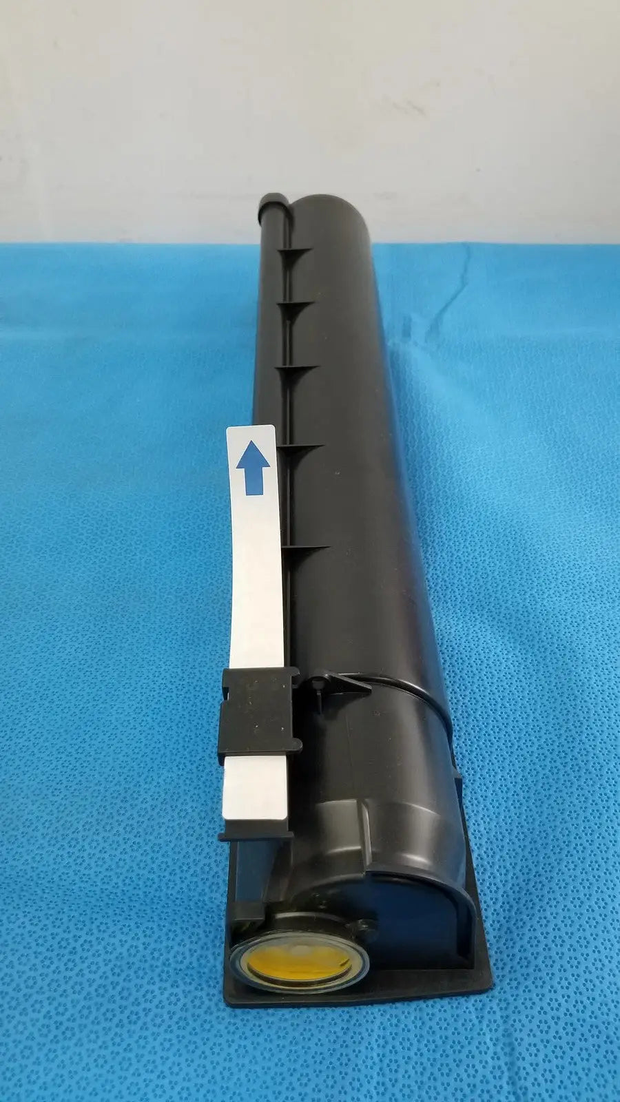 Black cylindrical genuine Toshiba toner cartridge T-FC28-Y with white label and yellow base component for printers