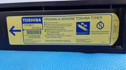 Yellow genuine toshiba toner t-fcc28-y original cartridge with black plastic casing and multilingual printed instructions