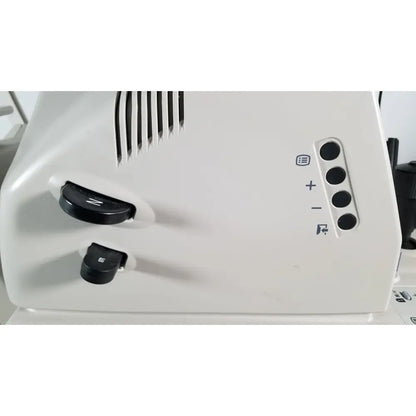 White plastic sewing machine with black control knobs and four circular buttons for tracey itrace visual function wsl524m