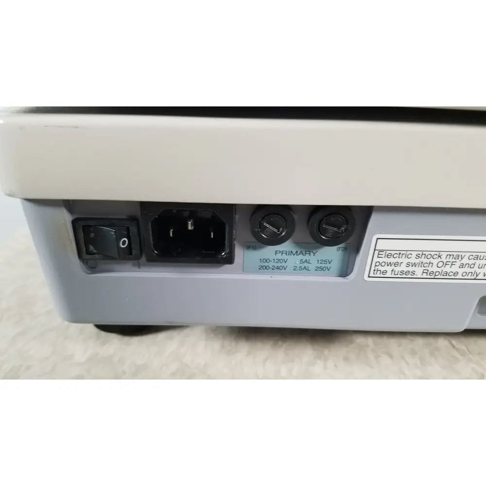 Back view of gray plastic power supply unit with black switch and ac socket on tracey itrace visual function analyzer wsl524m