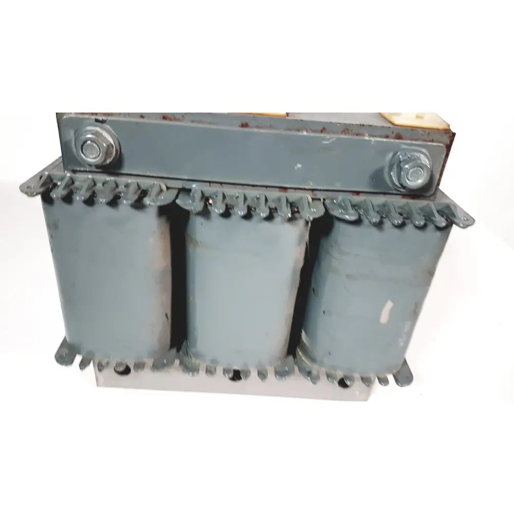 Gray trafo jordi ch-4950 huttwil transformer with three cylindrical cores and bolted metal casing industrial design