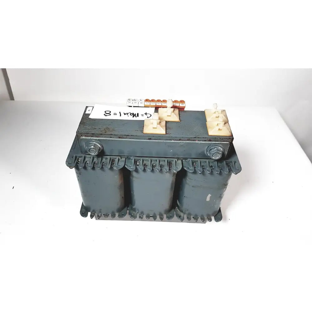 Dark gray industrial trafo jordi ch-4950 huttwil transformer with three cylindrical cores and beige terminal blocks featuring a handwritten label