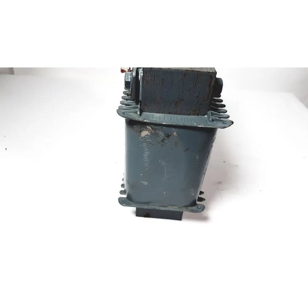 A weathered dark green industrial trafo jordi ch-4950 huttwil transformer with rectangular body and mounting flanges