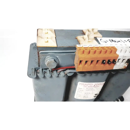 Orange and white electrical terminal block mounted on gray industrial trafo jordi ch-4950 huttwil transformer