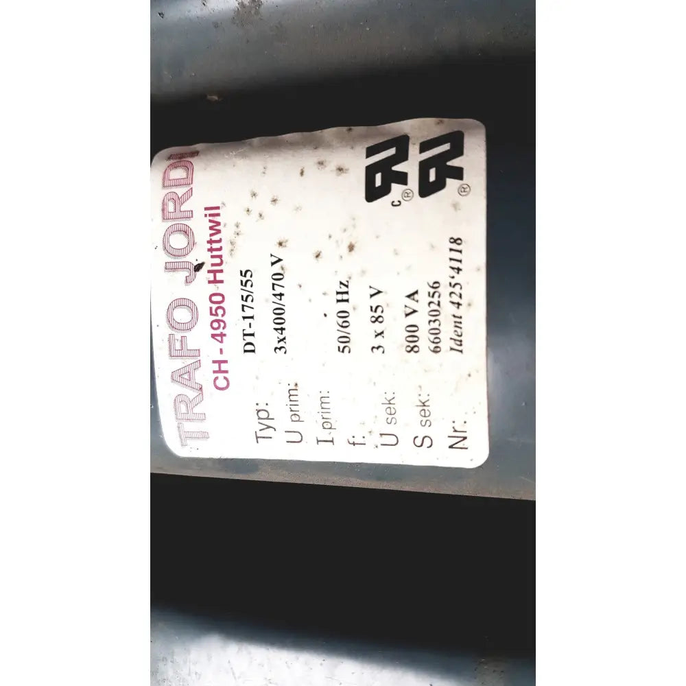 A white label with black and red text showing trafo jordi ch-4950 technical specifications on huttwil transformer dt-175/55